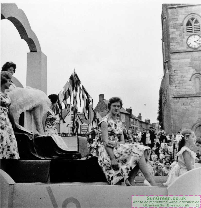 Tha same carnival float passin the Town Hall